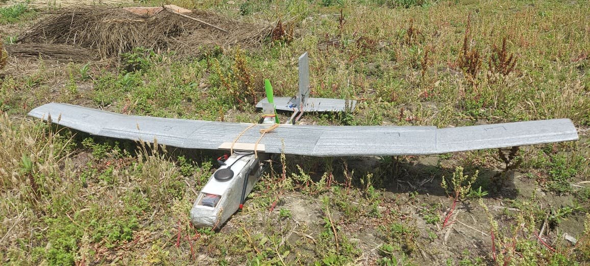 Fixed-wing UAS prototype on grass, with telemetry and GPS antennas